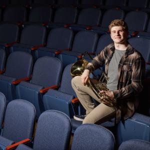 Shane Duffy sitting with his instrument.