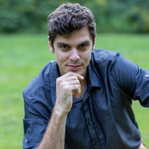 Andrey Stolyarov posing for his portrait outside.