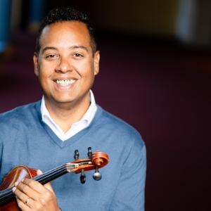 Michael Jorgensen holding a violin for his portrait