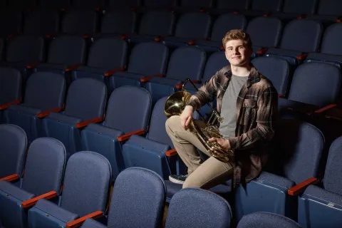 Shane Duffy sitting with his instrument.