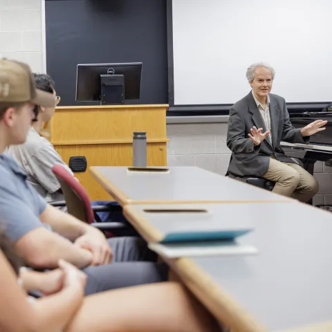 Professor teaching students in a classroom.
