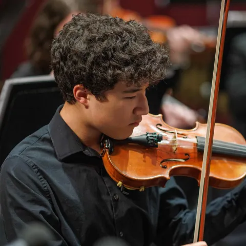 Orchestra student playing the violin.