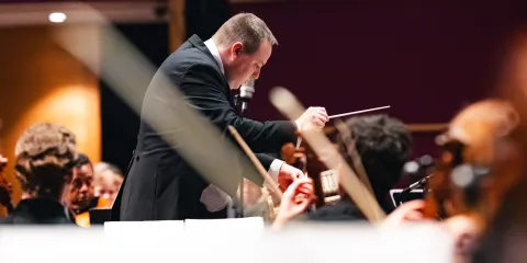 Kyle Wernke conducting a band.
