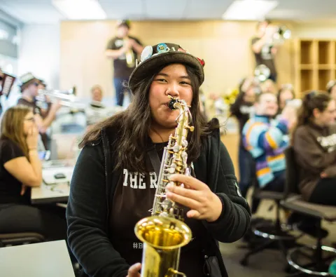 Music hero image - Student playing saxophone.