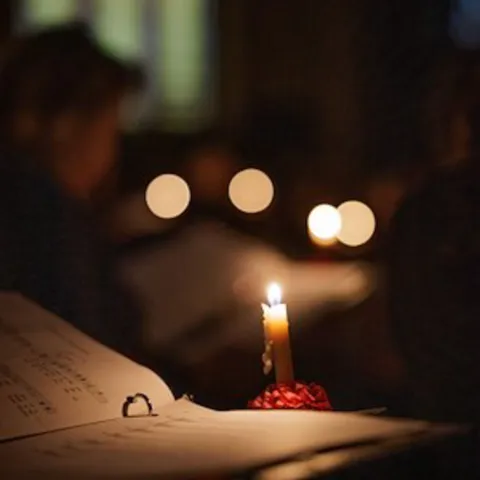 Choral music sheet with candlelight 