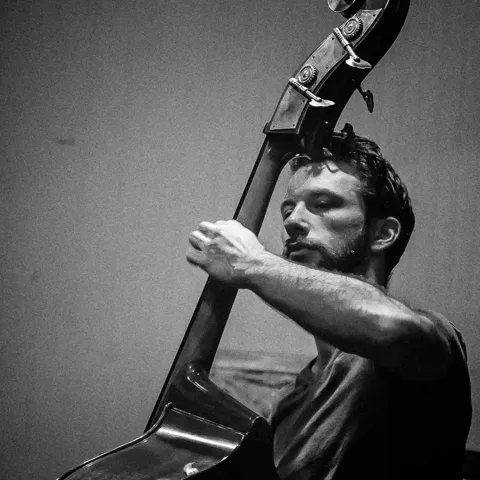 Grimm playing the cello.