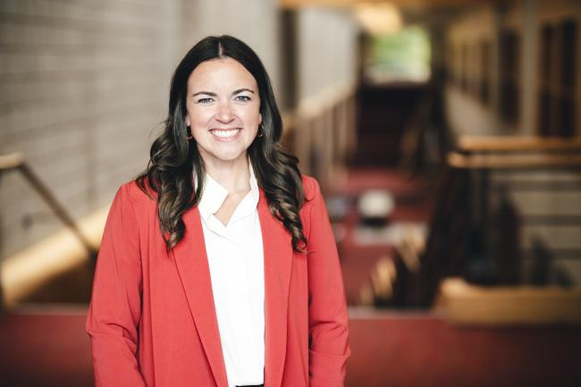 Liz Olsen standing for her portrait in the Zoellner Arts Center atrium.