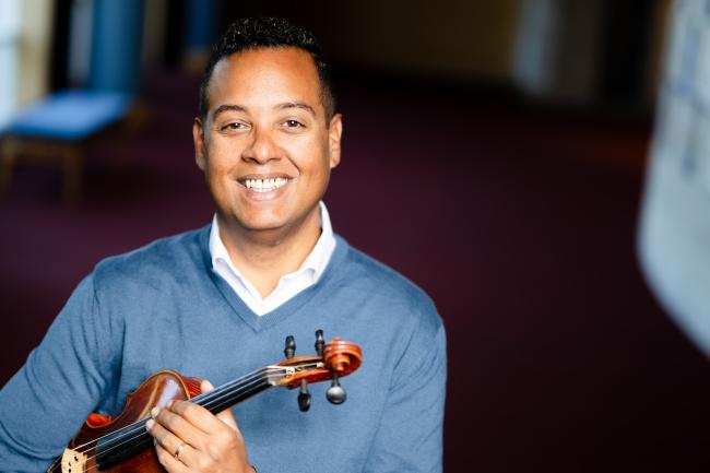 Michael Jorgensen holding a violin for his portrait