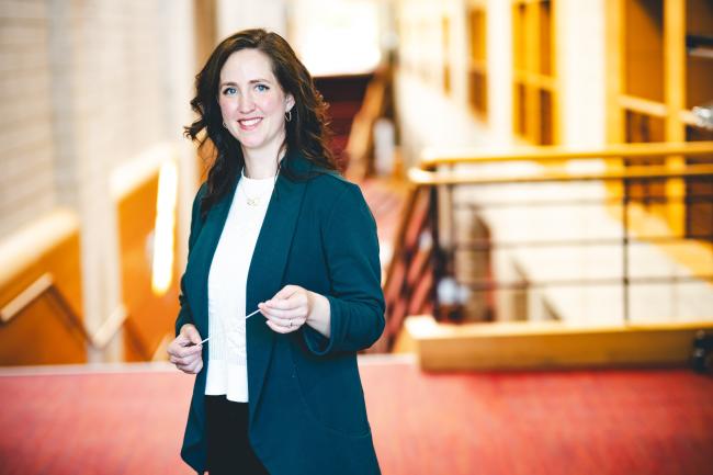 Sarah Frook Gallo standing for her portrait in the Zoellner Arts Center