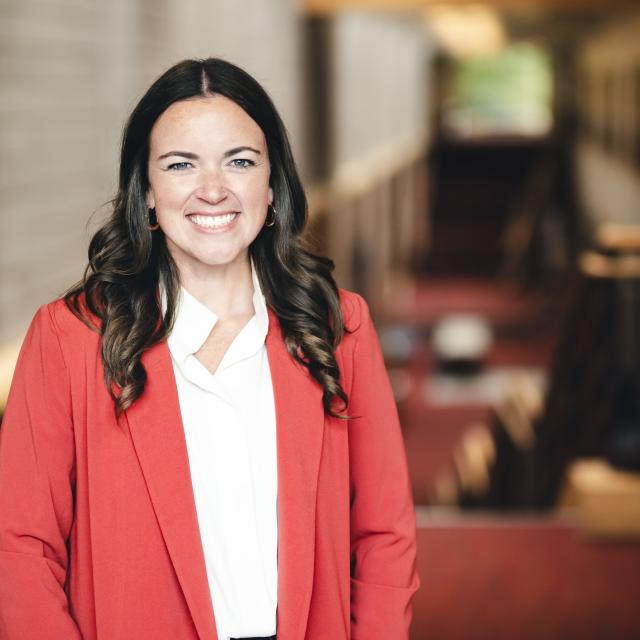 Liz Olsen standing for her portrait in the Zoellner Arts Center atrium.