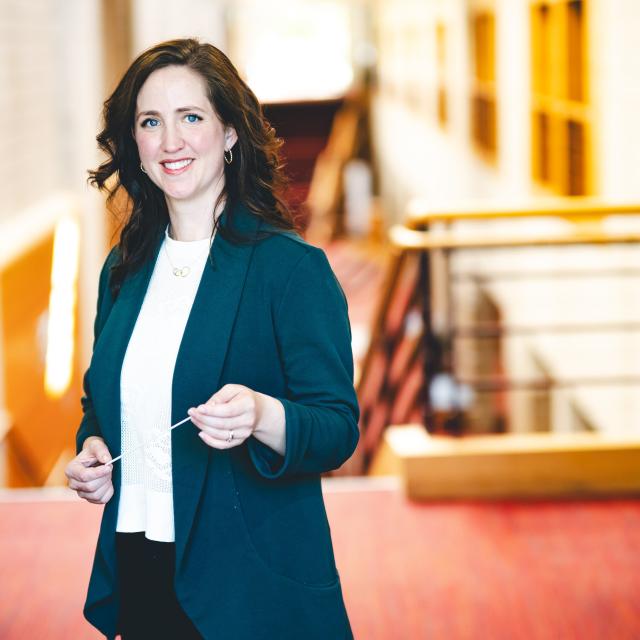 Sarah Frook Gallo standing for her portrait in the Zoellner Arts Center