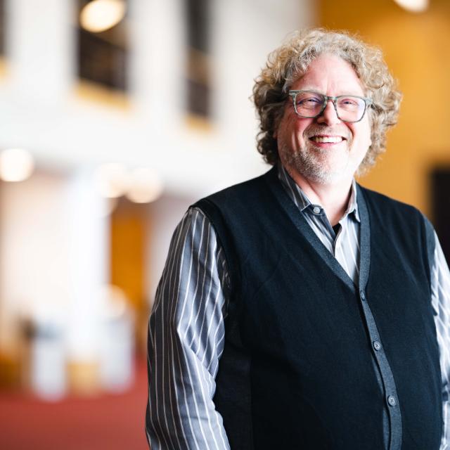 Darin Lewis standing for his portrait in the Zoellner Arts Center.