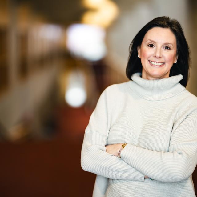 Lisa Basara standing with her arms crossed for her portrait in Zoellner Arts Center.