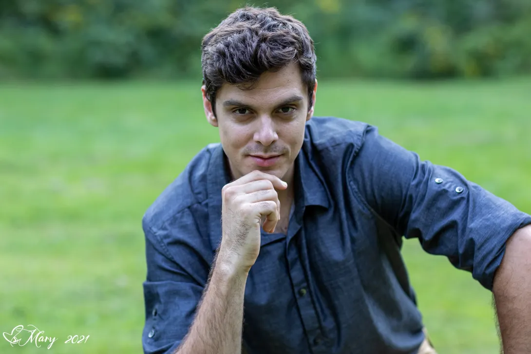 Andrey Stolyarov posing for his portrait outside.