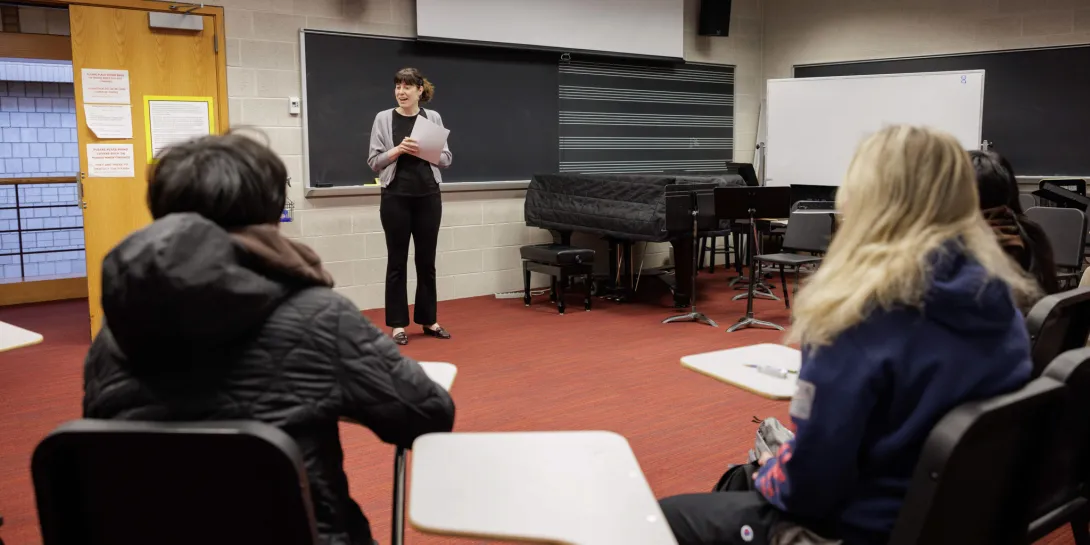 Monica Hershberger teaching to three students in a classroom.