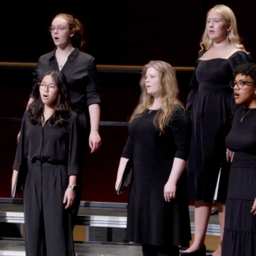 Members of the Lehigh University Dolce Choir signing on stage.